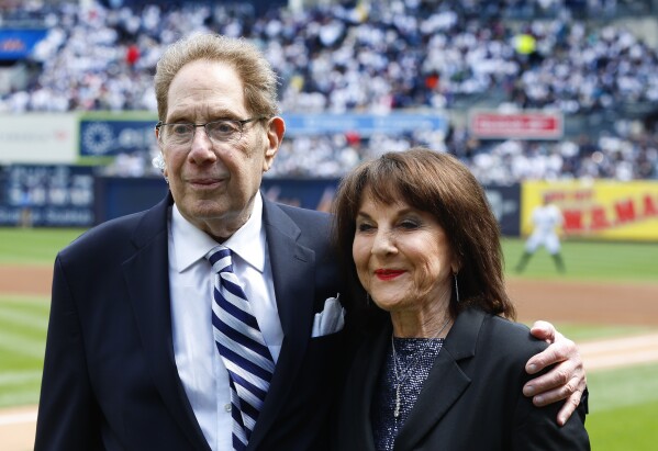 New York Yankees broadcasters John Sterling and Suzyn Waldman pose during a retirement ceremony for Sterling before a baseball game against the Tampa Bay Rays at Yankee Stadium in New York, Saturday, April 20, 2024. (AP Photo/Noah K. Murray)