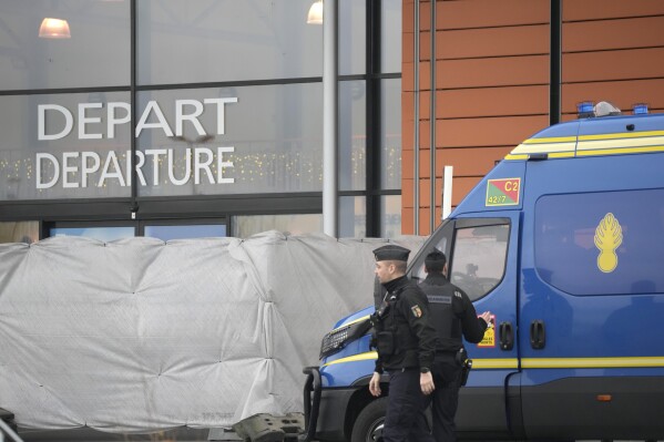 Gendarmes patrol at the Vatry airport, eastern France, Saturday, Dec. 23, 2023 in Vatry, eastern France. About 300 Indian citizens heading to Central America were sequestered in a French airport for a third day Saturday because of an investigation into suspected human trafficking, authorities said. The 15 crew members of the Legend Airlines charter flight en route from United Arab Emirates to Nicaragua were questioned and released, according to a lawyer for the small Romania-based airline. (AP Photo/Christophe Ena)