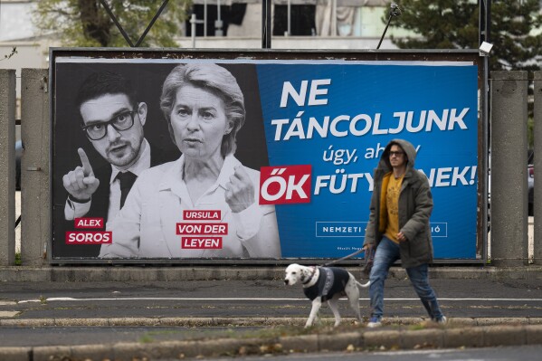 A government billboard reading "Let's not dance to their tune" is seen with portraits of Alex Soros and Ursula von der Leyen in downtown Budapest, Hungary, Monday, Nov. 20, 2023. A countrywide billboard campaign that flooded the streets of Hungary this week takes aim at the head of the European Union's executive Ursula von der Leyen, the start of an election campaign that marks an escalation of tensions between the country's right-wing government and the EU. (AP Photo/Denes Erdos)