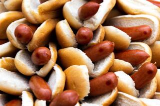 A Nathan's employee arranges 76 hot dogs on a plate at a weigh-in before the Nathan's Famous July Fourth hot dog eating contest, Friday, July 1, 2022, in New York. On Friday, April 21, 2023, The Associated Press reported on false claims that New York's mayor was banning meat in the city. (AP Photo/Julia Nikhinson)