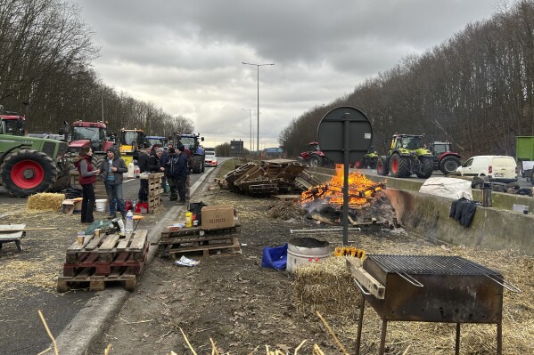 FILE - A delegation from the Belgian Young Farmers' Association blocked the main Paris-Brussels motorway for the third consecutive day in Halle, on the outskirts of the Belgian capital, on Tuesday, January 30, 2024. Like their fellow farmers across the European Union, they demand less bureaucracy and more money for their crops.  (AP Photo/Raf Cassart, File)