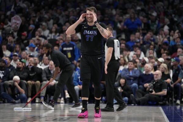 Dallas Mavericks guard Luka Doncic (77) smiles as he walks up court during the second half of an NBA basketball game against the Houston Rockets in Dallas, Tuesday, Nov. 28, 2023. (AP Photo/Tony Gutierrez)