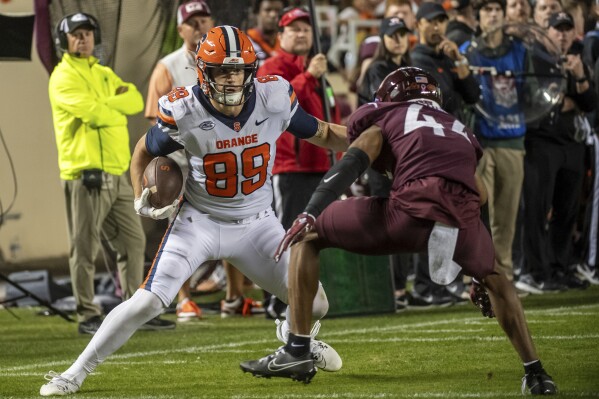 Syracuse's Dan Villari (89) is defended by Virginia Tech's Dorian Strong (44) during the second half of an NCAA college football game Thursday, Oct. 26, 2023, in Blacksburg, Va. (AP Photo/Robert Simmons)