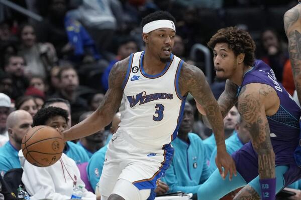 Washington Wizards guard Bradley Beal (3) moves past Charlotte Hornets guard Kelly Oubre Jr., right, during the first half of an NBA basketball game in Washington, Sunday, Nov. 20, 2022. (AP Photo/Susan Walsh)
