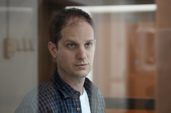 FILE - Wall Street Journal reporter Evan Gershkovich stands in a glass cage in a courtroom at the Moscow City Court in Moscow, Russia, on Oct. 10, 2023. A court in Moscow on Tuesday Nov. 28, 2023 ruled to extend the detention of Wall Street Journal reporter Evan Gershkovich, arrested on espionage charges, till Jan. 30. (AP Photo/Alexander Zemlianichenko, File)