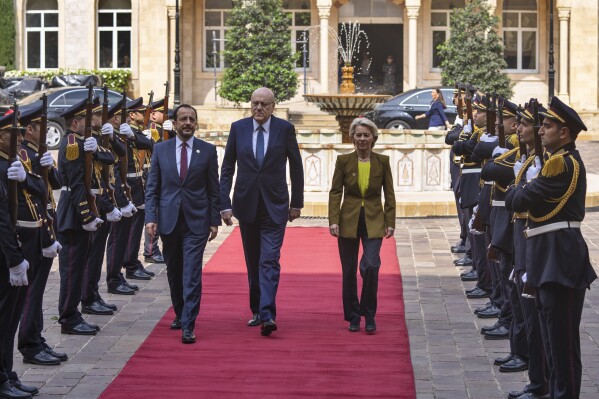 Lebanese caretaker Prime Minister Najib Mikati, center, welcomes Cyprus' President Nikos Christodoulides, left, and President of the European Commission Ursula von der Leyen at the government palace in Beirut, Lebanon, Thursday, May 2, 2024. (AP Photo/Hassan Ammar)