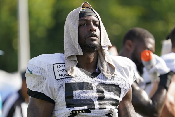 FILE - Then-Jacksonville Jaguars linebacker Rashod Berry cools off while taking a break during an NFL football practice, Saturday, July 30, 2022, in Jacksonville, Fla. The NFL suspended three players indefinitely Thursday, June 29, 2023, for violating the league's gambling policy and a fourth was sidelined for six games. Isaiah Rodgers and Rashod Berry of the Indianapolis Colts along with free agent Demetrius Taylor received indefinite suspensions through at least this season for betting on NFL games in 2022.(AP Photo/John Raoux, File)