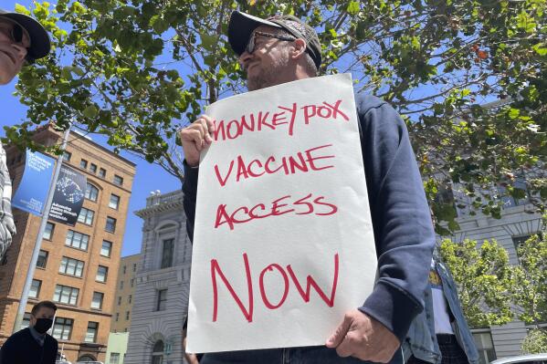 FILE - A man holds a sign urging increased access to the monkeypox vaccine during a protest in San Francisco on July 18, 2022. With monkeypox cases subsiding in Europe and parts of North America, many scientists say now is the time to prioritize stopping the virus in Africa. (AP Photo/Haven Daley, File)