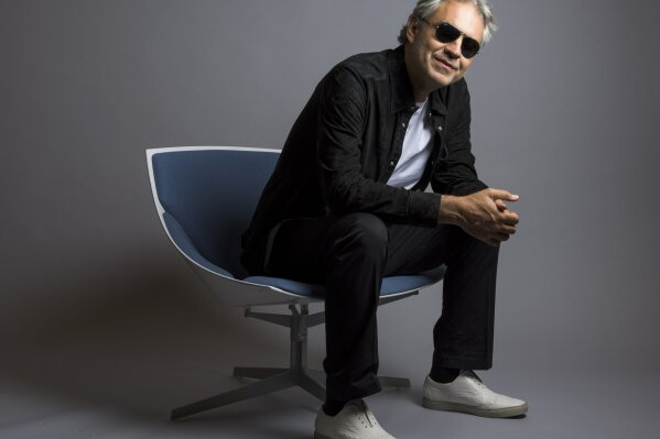 FILE - In this Oct. 29, 2015 file photo, Andrea Bocelli poses for a portrait in New York. Bocelli has released an album, "Cinema," which includes a duet with pop star Ariana Grande. Bocelli will sing at the Duomo of Milan on Easter Sunday sending a message of love and hope to the world during the coronavirus pandemic, but the Italian tenor says it’s not a concert. Instead, he calls it a “prayer.” (Photo by Drew Gurian/Invision/AP, File)