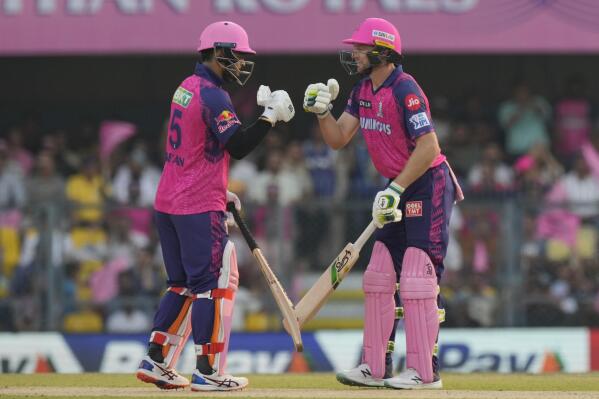 Rajasthan Royals's Jos Buttler, right, celebrates scoring fifty runs with his teammate Ryan Parag during the Indian Premier League (IPL) cricket match between Rajasthan Royals and Delhi Capitals in Guwahati, India, Thursday, April 6, 2023. (AP Photo/Anupam Nath)