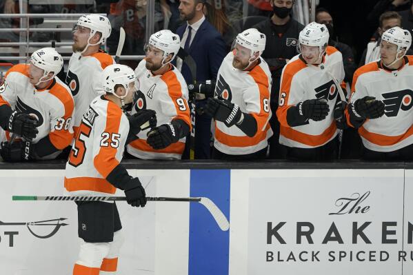 Philadelphia Flyers left wing James van Riemsdyk (25) is greeted by teammates after he scored a goal against the Seattle Kraken during the first period of an NHL hockey game, Wednesday, Dec. 29, 2021, in Seattle. (AP Photo/Ted S. Warren)