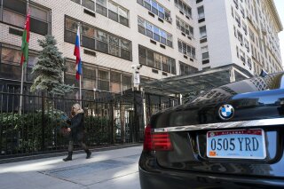 
              A woman walks past the Permanent Mission of the Russian Federation in New York Monday, March 26, 2018. The United States and more than a dozen European nations kicked out Russian diplomats on Monday and the Trump administration ordered Russia's consulate in Seattle to close, as the West sought joint punishment for Moscow's alleged role in poisoning an ex-spy in Britain.  (AP Photo/Craig Ruttle)
            