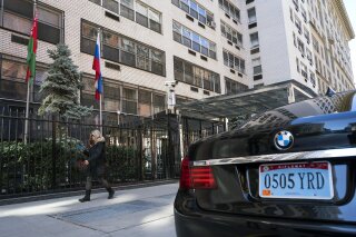 A woman walks past the Permanent Mission of the Russian Federation in New York Monday, March 26, 2018. The United States and more than a dozen European nations kicked out Russian diplomats on Monday and the Trump administration ordered Russia's consulate in Seattle to close, as the West sought joint punishment for Moscow's alleged role in poisoning an ex-spy in Britain. (AP Photo/Craig Ruttle)