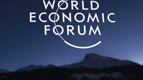 A mountain reflected in a car window with the sign of the WEF, ahead of the annual meeting of the World Economic Forum, in Davos, Saturday, Jan. 19, 2019. (AP Photo/Markus Schreiber)