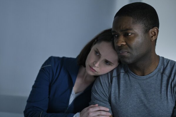 This image released by Netflix shows Felicity Jones, left, and David Oyelowo in a scene from "The Midnight Sky." (Philippe Antonello/Netflix via AP)