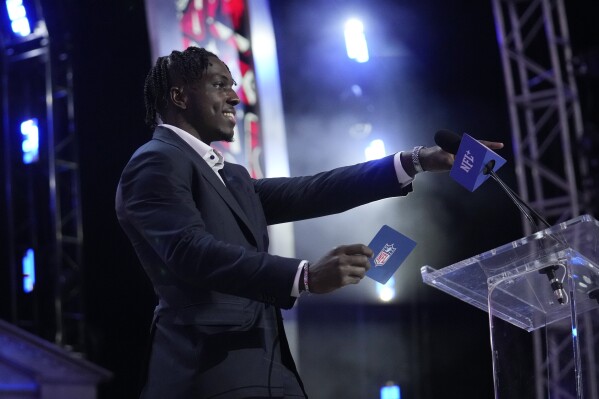 Houston Texans' Christian Harris announces a pick for the Houston Texans during the second night of the NFL football draft, Friday, April 26, 2024, in Detroit. (AP Photo/Jeff Roberson)