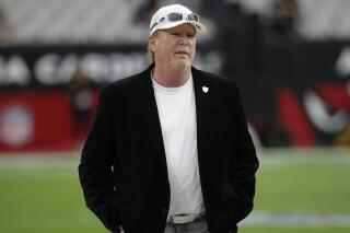 FILE - In this Aug. 15, 2019, file photo, Raiders owner Mark Clark Davis stands on the field before the team's NFL football game against the Arizona Cardinals in Glendale, Ariz. The Las Vegas Raiders got angry backlash for a tweet the team sent after Minneapolis police officer Derek Chauvin was convicted of murdering George Floyd. Davis said he was driving the verdict was announced and heard Floyd's brother, Philonise, make the statement that “we can all breathe again” and decided to make that message the team's response. (AP Photo/Rick Scuteri, File)