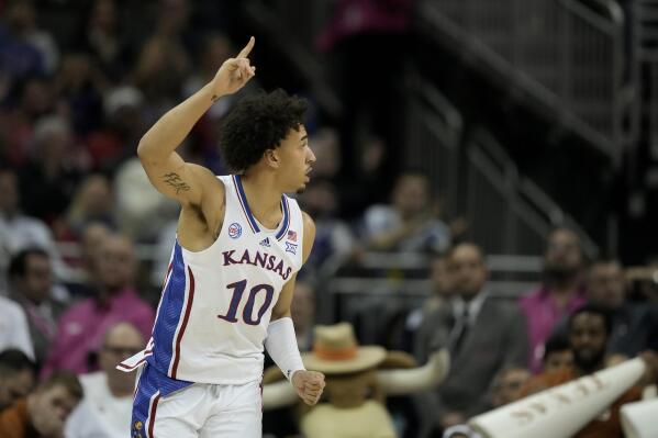 Kansas forward Jalen Wilson celebrates after making a basket during the first half of the NCAA college basketball championship game against Texas in the Big 12 Conference tournament Saturday, March 11, 2023, in Kansas City, Mo. (AP Photo/Charlie Riedel)