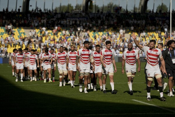 Japan players wave to fans at the end of the Rugby World Cup Pool D match between Japan and Argentina at the Stade de la Beaujoire in Nantes, western France, Sunday, Nov. 8, 2023. (AP Photo/Lewis Joly)