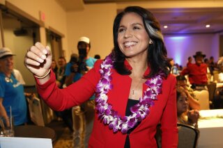 
              FILE - In this Nov. 6, 2018, file photo, Rep. Tulsi Gabbard, D-Hawaii, greets supporters in Honolulu. Gabbard has announced she’s running for president in 2020. The 37-year-old Gabbard said in a CNN interview slated to air Saturday night that she will be formally announcing her candidacy within the week. (AP Photo/Marco Garcia, File)
            