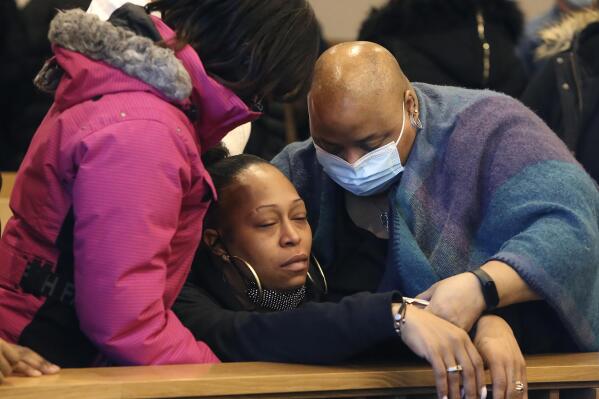 LaToya Minus, center, mother of slain Dejah Jenkins-Minus, 22, of Boston, is assisted by family and friends at the arraignment of Leonard D. Robinson, 22, of Lowell, Mass., in Lowell District Court, in Lowell, Tuesday, Nov. 30, 2021. Robinson faces a murder charge in the death of Dejah Jenkins-Minus, who was found dead of "multiple sharp force injuries" by police conducting a well-being check on Friday, Nov. 26, according to a statement from the office of Middlesex District Attorney Marian Ryan. (Julia Malakie/The Lowell Sun via AP)