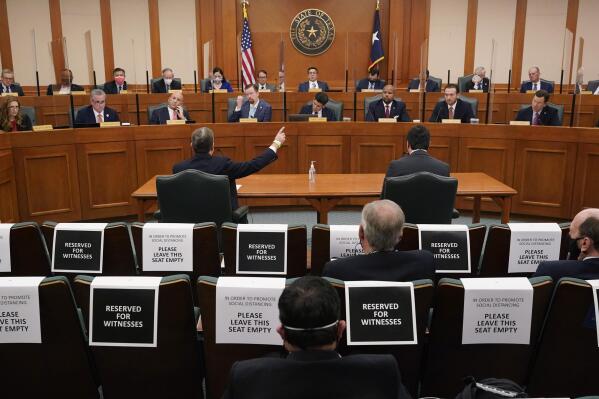 FILE - In this Feb. 25, 2021 file photo, Curtis Morgan, the CEO of Vistra Corp., at table left, testifies as the Committees on State Affairs and Energy Resources holds a joint public hearing to consider the factors that led to statewide electrical blackouts, in Austin, Texas. Only days remain for Texas lawmakers to make good on promised overhauls following one of the largest power outages in U.S. history, when more than 4 million customers lost heat after an artic blast buckled the state's electric grid. (AP Photo/Eric Gay,File)