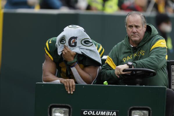 Green Bay Packers wide receiver Randall Cobb covers his face as he is carted off the field during the second half of an NFL football game against the New York Jets, Sunday, Oct. 16, 2022, in Green Bay, Wis. (AP Photo/Matt Ludtke)