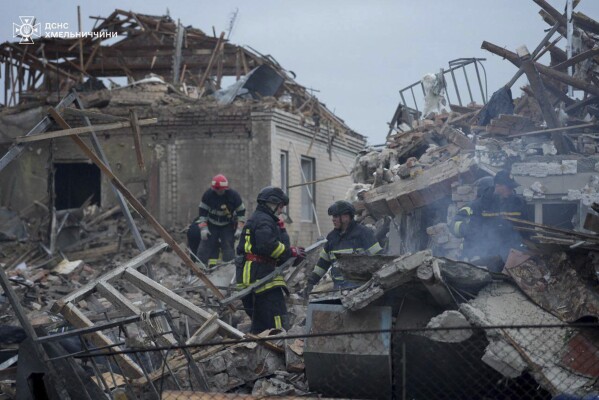 In this photo provided by the Ukrainian Emergency Service, firefighters search for victims following a Russian air attack in Khmelnytskyi region, Ukraine, Sunday, May 25, 2025. (Ukrainian Emergency Service via AP)