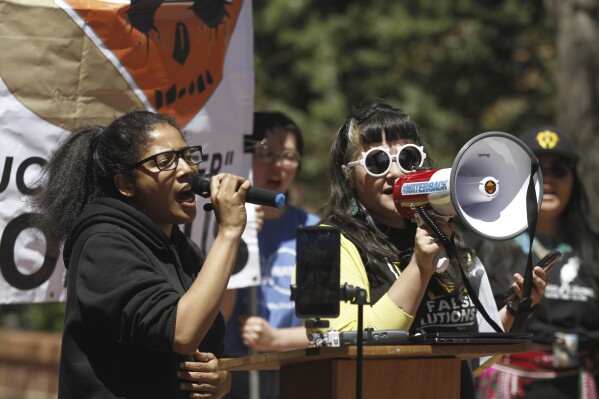 Destiny Ray, right, of YouthUnited for Climate Crisis Action, speaks at a rally outside the New Mexico Statehouse against rules for the treatment and recycling of oil-industry fracking water, Monday, May 6, 2024, in Santa Fe, N.M. Environmental officials in the nation's No. 2 state for petroleum production are taking initial steps toward regulating the treatment and reuse of oil-industry fracking water. New Mexico has been grappling with scarce water supplies, and fossil fuel producers are confronting shrinking opportunities for water disposal. The state's Water Quality Control Commission opened a weeklong series of hearings on Monday, May 13. (AP Photo/Morgan Lee)