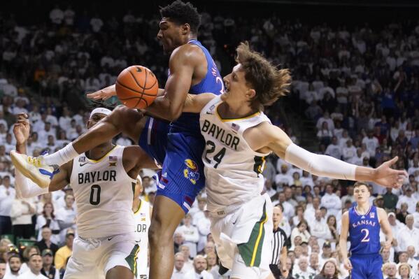 Kansas forward David McCormack, center, and Baylor guard Matthew Mayer try to get possession of the ball as Baylor forward Flo Thamba, left, watches during the first half of an NCAA college basketball game Saturday, Feb. 26, 2022, in Waco, Texas. (AP Photo/Ray Carlin)