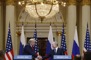 
              U.S. President Donald Trump, left, shakes hand with Russian President Vladimir Putin during a press conference after their meeting at the Presidential Palace in Helsinki, Finland, Monday, July 16, 2018. (AP Photo/Alexander Zemlianichenko)
            