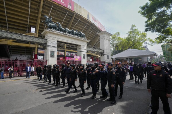 Police agents stand guard at the Plaza Mexico before a bullfighting in Mexico City, Sunday, Jan.  28, 2024. (AP Photo/Fernando Llano)