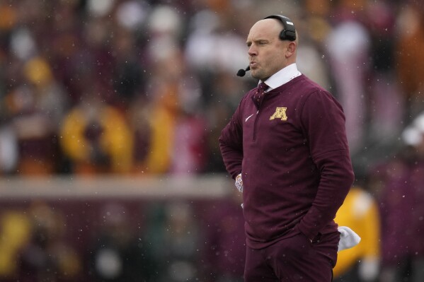 Minnesota head coach P. J. Fleck stands on the sideline during the first half of an NCAA college football game against Wisconsin, Saturday, Nov. 25, 2023, in Minneapolis. (AP Photo/Abbie Parr)