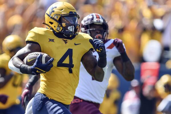 West Virginia running back Leddie Brown (4) rushes for a touchdown against Virginia Tech during the first half of an NCAA college football game in Morgantown, W.Va., Saturday, Sept. 18, 2021. (AP Photo/William Wotring)