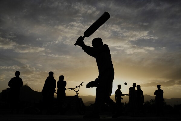 Afghans play cricket at the Chaman-e-Hozari Park in Kabul, Afghanistan, Friday, May 30, 2025. (AP Photo/Ebrahim Noroozi)