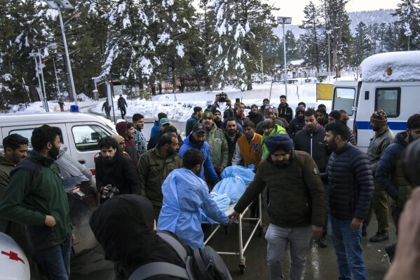 A paramedic and volunteers transport the body of a Russian skier to a hospital in Tangmarg, near Gulmarg, a popular skiing destination in Indian controlled Kashmir, Thursday, Feb. 22, 2024. Officials say that the Russian skier was killed by an avalanche that hit Gulmarg on Thursday. (APPhoto/Dar Yasin)