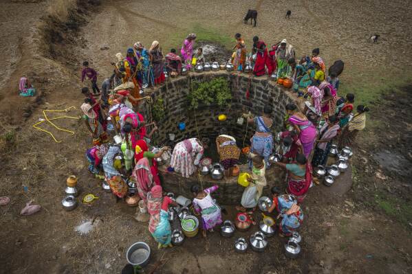 Villagers gather around a well to draw water in Telamwadi, northeast of Mumbai, India, Saturday, May 6, 2023. Collecting water from outside wells is a common task in this rural area, which has seen increasing protests as more river water from dams is diverted to urban areas. "We're very angry," says a social worker who serves many of the 154 villages in the Thane district. "This is our rain." (AP Photo/Dar Yasin)