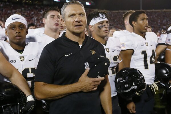 
              Army head coach Jeff Monken stands with his team after of an NCAA college football game against Oklahoma in Norman, Okla., Saturday, Sept. 22, 2018. Oklahoma won 28-21 in overtime. (AP Photo/Sue Ogrocki)
            