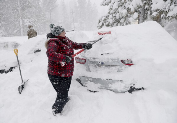 Janna Gunnels digs out her car along North Lake Boulevard as snow continues to fall in Tahoe City, Calif., on Saturday, March 2, 2024. (Jane Tyska/Bay Area News Group via AP)