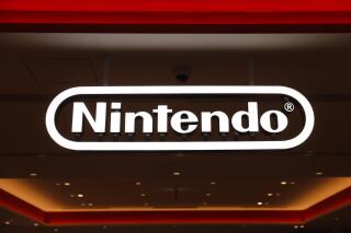 In this Jan. 23, 2020, photo, a Nintendo sign is seen at the company's official store in the Shibuya district of Tokyo, Thursday, Jan. 23, 2020. Japanese video-game maker Nintendo Co. has scored a 33% jump in annual profit as people stuck at home during the coronavirus pandemic turn to playing games. (AP Photo/Jae C. Hong)