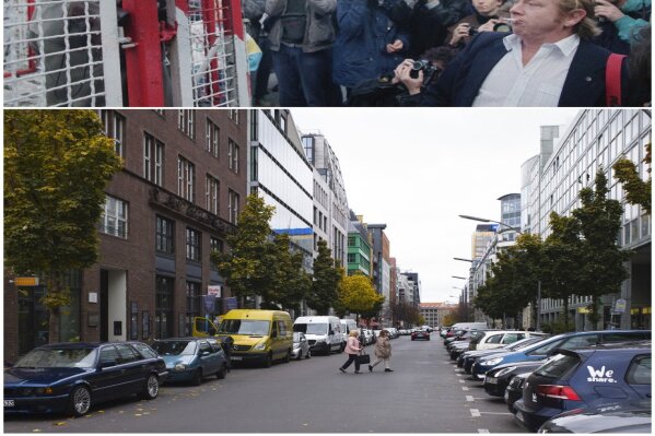 This combination of photos shows an East German border guard making a fist to some demonstrators, top, on Oct. 7, 1989, who who threw bottles on the eastern side of newly-erected barriers at the allied Checkpoint Charlie crossing point and the same location on Nov. 5, 2019, where people cross the street near where the former allied Checkpoint Charlie was located. (AP Photo/Markus Schreiber)