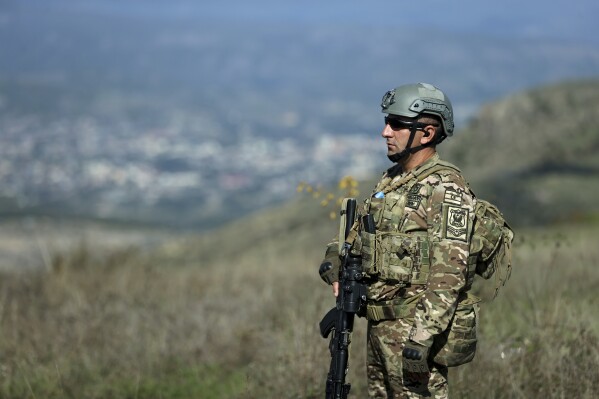 An Azerbaijani serviceman on patrol on Tuesday, Oct. 3, 2023, near Khankendi, Azerbaijan, also known as Stepanakert to Armenians. (AP Photo/Aziz Karimov)