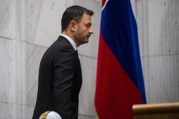 Slovakia's Prime Minister Eduard Heger leaves the hall ahead of a confidence vote for his Cabinet at the parliament session in Bratislava, Thursday, Dec. 15, 2022. Slovakia’s coalition government has fallen after losing a parliamentary no-confidence vote Thursday, a move that could lead to an early election. (Jaroslav Novak/TASR via AP)