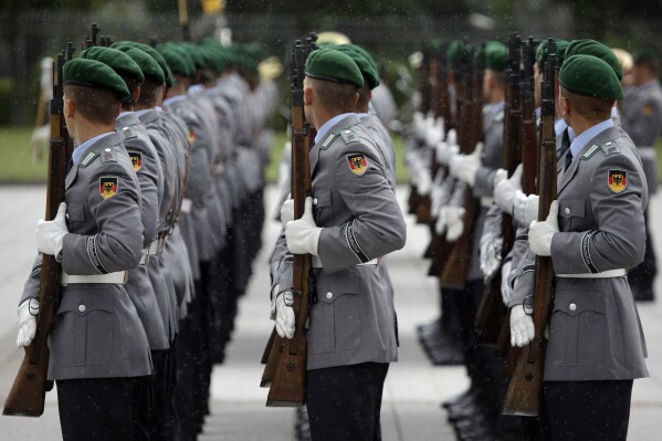 FILE - Soldiers of the honor guard prepare for a military welcome ceremony as part of a meeting of German Defence Minister Ursula von der Leyen and her counterpart from Great Britain Michael Fallon, in Berlin, Germany, Tuesday, Aug. 12, 2014. The German defense ministry says that it has received 178 applications for compensation by gay servicepeople who experienced discrimination in the military before a change of policy more than 20 years ago. (AP Photo/Michael Sohn, File)