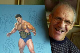 FILE - In this Nov. 30, 2000, file photo, former pro wrestler Bruno Sammartino poses with a painting of him in his Pittsburgh home.   A Pittsburgh suburb on Friday, April 23, 2021 honored Sammartino by renaming a park in the longtime resident's honor. Sangree Park in Ross Township will be known as Sammartino Park, after the man who lived in the community for more than 50 years. (AP Photo/Gene J. Puskar, File)