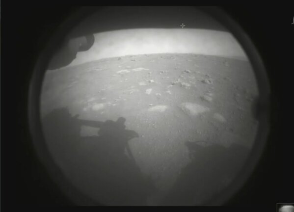 This photo made available by NASA shows the first image sent by the Perseverance rover showing the surface of Mars, just after landing in the Jezero crater, on Thursday, Feb. 18, 2021. (NASA via AP)