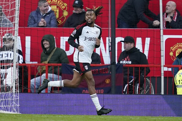 Fulham's Alex Iwobi celebrates scoring his side's second goal during the English Premier League soccer match between Manchester United and Fulham at Old Trafford stadium in Manchester, Saturday, Feb. 24, 2024.(AP Photo/Dave Thompson)