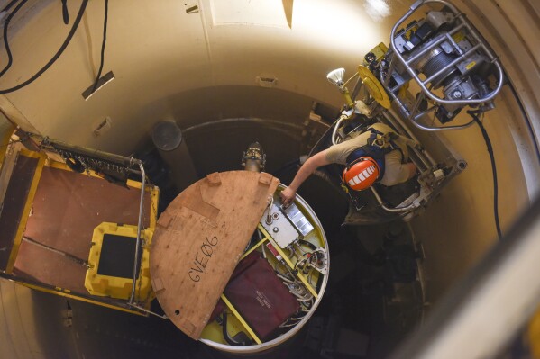 FILE - In this image provided by the U.S. Air Force, Airman 1st Class Jackson Ligon, 341st Missile Maintenance Squadron technician, examines the internals of an intercontinental ballistic missile during a Simulated Electronic Launch-Minuteman test Sept. 22, 2020, at a launch facility near Malmstrom Air Force Base in Great Falls, Mont. The Air Force is reporting the first data on cancer diagnoses among troops who worked with nuclear missiles. While the data is only about 25% complete, the Air Force on March 13, 2024, said the numbers are lower than they would have expected.(Tristan Day/U.S. Air Force via AP)