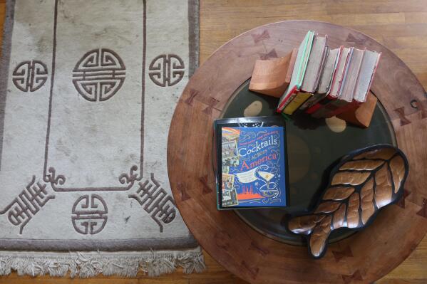 A Chinese rug purchased in Beijing in 1979 rests next to a Thai coffee table made from wood and a metal truck wheel bought in Bangkok in 2015. When you live in a multigenerational house, opportunities to blend past and present abound. (AP Photo/Ted Anthony)