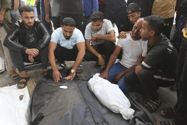 Palestinians mourn relatives killed in Israeli bombardment on the Gaza Strip, outside a morgue in Rafah, Friday, Oct. 27, 2023. (AP Photo/Hatem Ali)